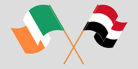 Crossed and waving flags of Ireland and Yemen