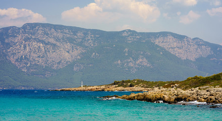 Shore of the island in the Aegean Sea on a background of mountains