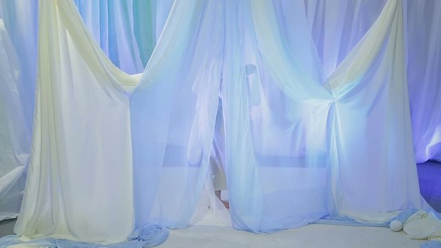 Young Jewish bride rehearsing an exit under the chuppah before the wedding