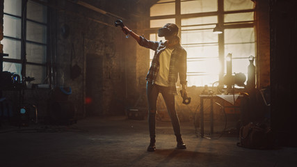 Naklejka na ściany i meble Talented Female Artist Wearing Virtual Reality Headset and Holding Digital Joysticks. She's Working on a Painting or Sculpture, Uses Motion Controllers To Create Concept Art. Creative Modern Studio.