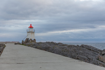 Lighthouse in Norwegian fjords, Norway. Sea mountain landscape view.