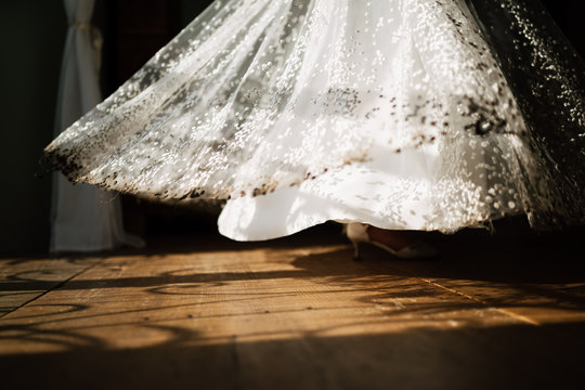 photo of a brides dress on a wooden floor