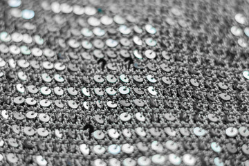 Texture of knitted fabric with sequins. Black and white texture