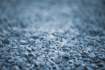 Background of pebbles. Pebble texture with a blue tint. Decorative rocks. Blue stone floor in the garden. Blue pebbles.