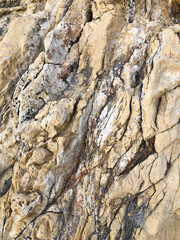 yellow grunge rock texture background with cracks.yellow mountain texture closeup. Cracked natural stone surface