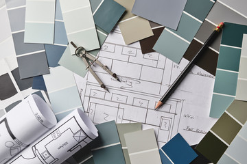 paint samples and house blueprints on a desk