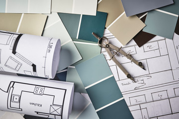 paint samples and house blueprints on a desk