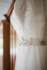 photo of a wedding dress hanged on a closet