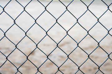 Fototapeta premium Stretched metal mesh on a blurred background