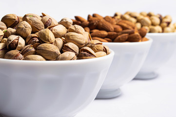Nuts in plates on a white background