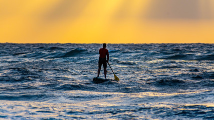 Surfing at Cicer Beach at sunset, Las Palmas de Gran Canaria - obrazy, fototapety, plakaty