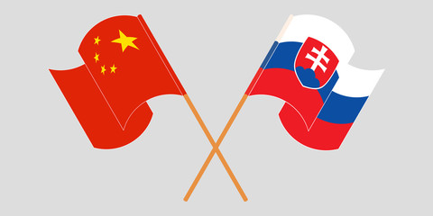 Crossed and waving flags of Slovakia and China