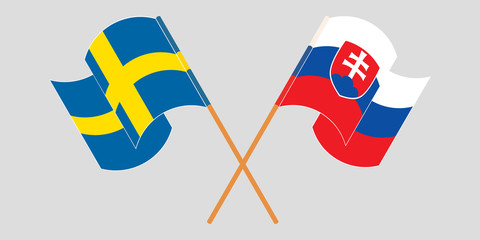 Crossed and waving flags of Slovakia and Sweden