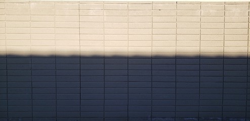 Wavy shadow on an adobe wall in soft, morning light.