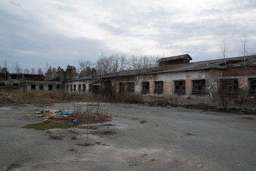 an old abandoned building with debris and broken Windows