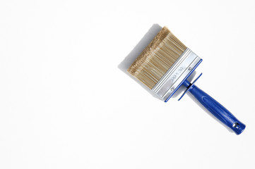 Decorator brush isolated on white background. Wide paintbrush usually used for painting walls, furniture and steel surfaces. Masonry brush with plastic handle and long bristles.