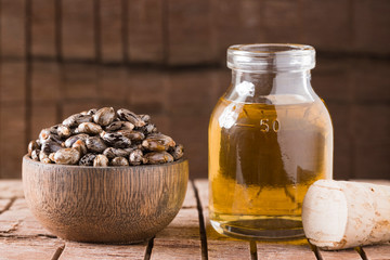 castor oil and seeds, on wooden background © Alexander Ruiz