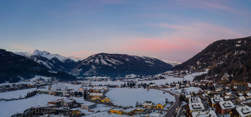 Panoramic view on Sankt Michael im Lungau at sunrise, Austria - January 2020. Aerial drone view.