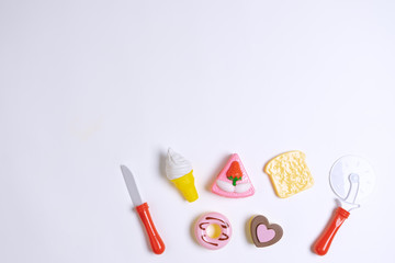 Collection of food toys for kids. Ice cream, slice of cake, donuts. Flay lay image. White background