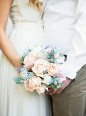 bride and groom holding a bouquet of flowers