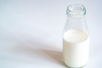 glass milk bottle on a white isolated background