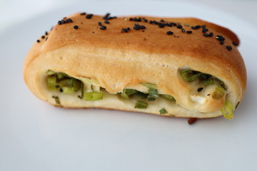 Baked buns as crispy biscuits, Okonomiyaki buns, filled with spring onions and topped with sesame, a easy vegetarian meal.
