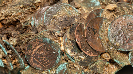A very closeup of a cluster of vintage Spanish shipwreck oxidized coins