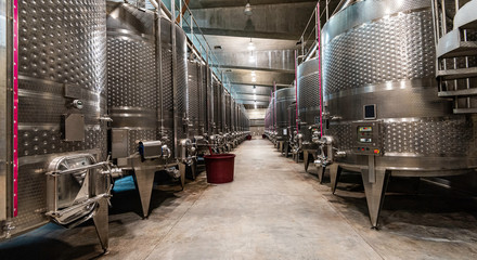 A wine cellar full of giant stainless steel vats