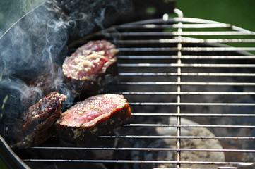 Grilled beef steaks with garlic. Selective focus.