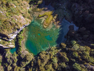 Aerial view of Magdalena Lagoon, in middle of forest, in Sierra de los Cuchumatanes, Huehuetenango, Guatemala