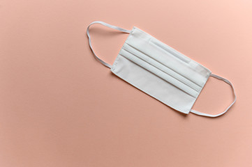 Reusable rag masks for the face on a pink background.
