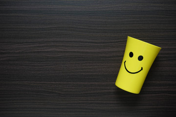 Yellow mug with smiley icon. Top view