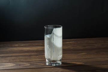 An empty glass of milk is standing on the table.