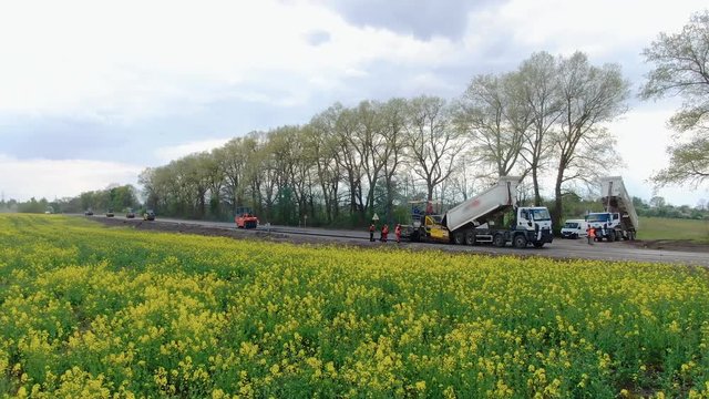 4K video. Side view of road works with asphalt paver