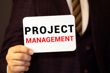 business man writing project management concept of time, cost and scope