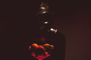 Masked person offering fruit after Coronavirus - Covid 19 Dark side