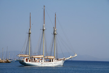 Fototapeta na wymiar A large white three-masted yacht at sea.