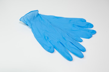 Blue nitrile medical gloves on white table