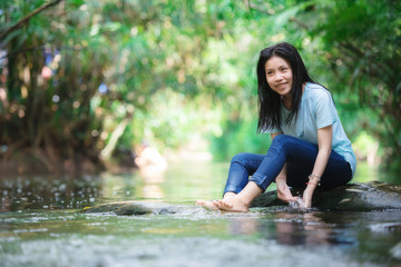 Young girl playing water stream