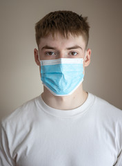 Young man wearing mask to protect against covid 19 disease
