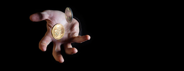 White male hand throwing two bitcoins - narrow banner with copy space