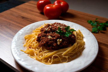 
Bolognese spaghetti in a porcelain plate with decoration