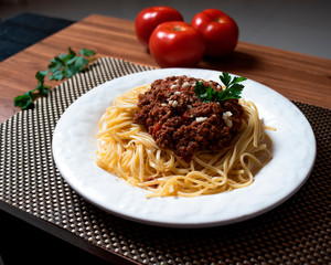 
Bolognese spaghetti in a porcelain plate with decoration