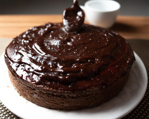 
Homemade chocolate cake in porcelain plate on wooden table