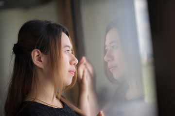 The girl was looking at the airport mirror.