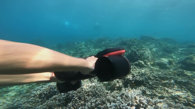 Guy snorkeling with seabob in deep sea water