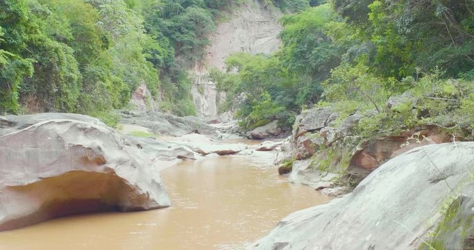Brown River Flowing Down Surrounded by Rocks and the Vegetation in Samaipata, Santa Cruz / Bolivia