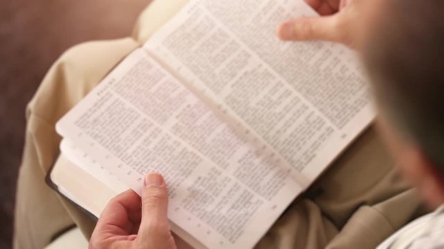 Close Up of a Man Reading the Holy Bible