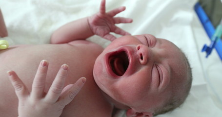 Infant newborn baby crying after birth, first seconds of life