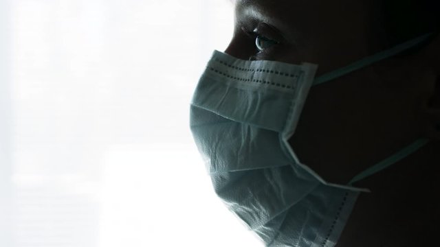 Wearing a medical mask during covid-19 pandemic by a nurse. Wearing protective face mask. Footage in 4K and HD. Download preview for free.